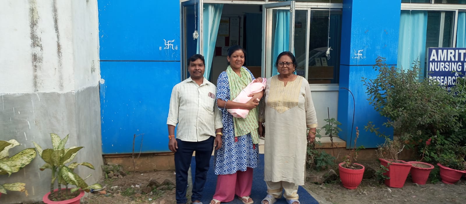 Happy family with newborn at Amrita Nursing Home
